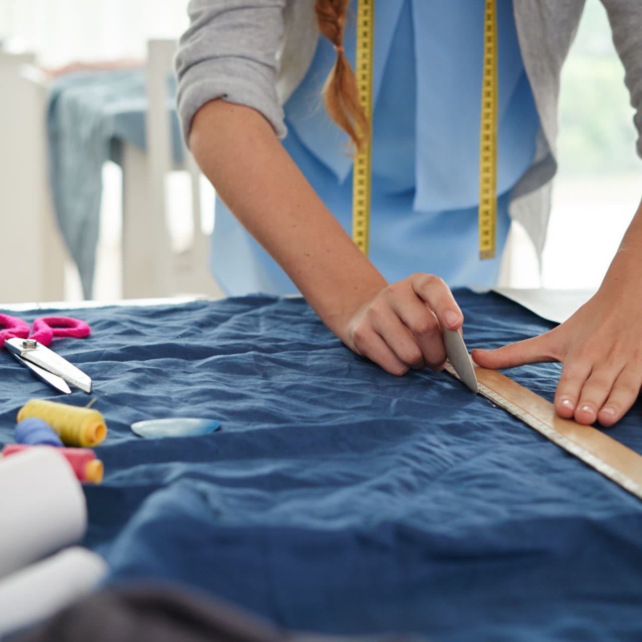 Tailor cutting fabric at the Forest-Side factory